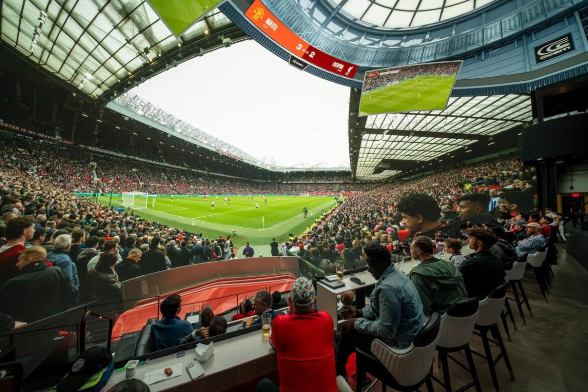 Fans watching football at a Cosm shared reality venue